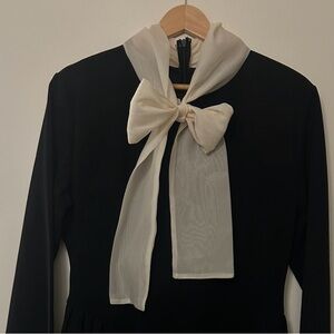Black cocktail dress with cream bow
